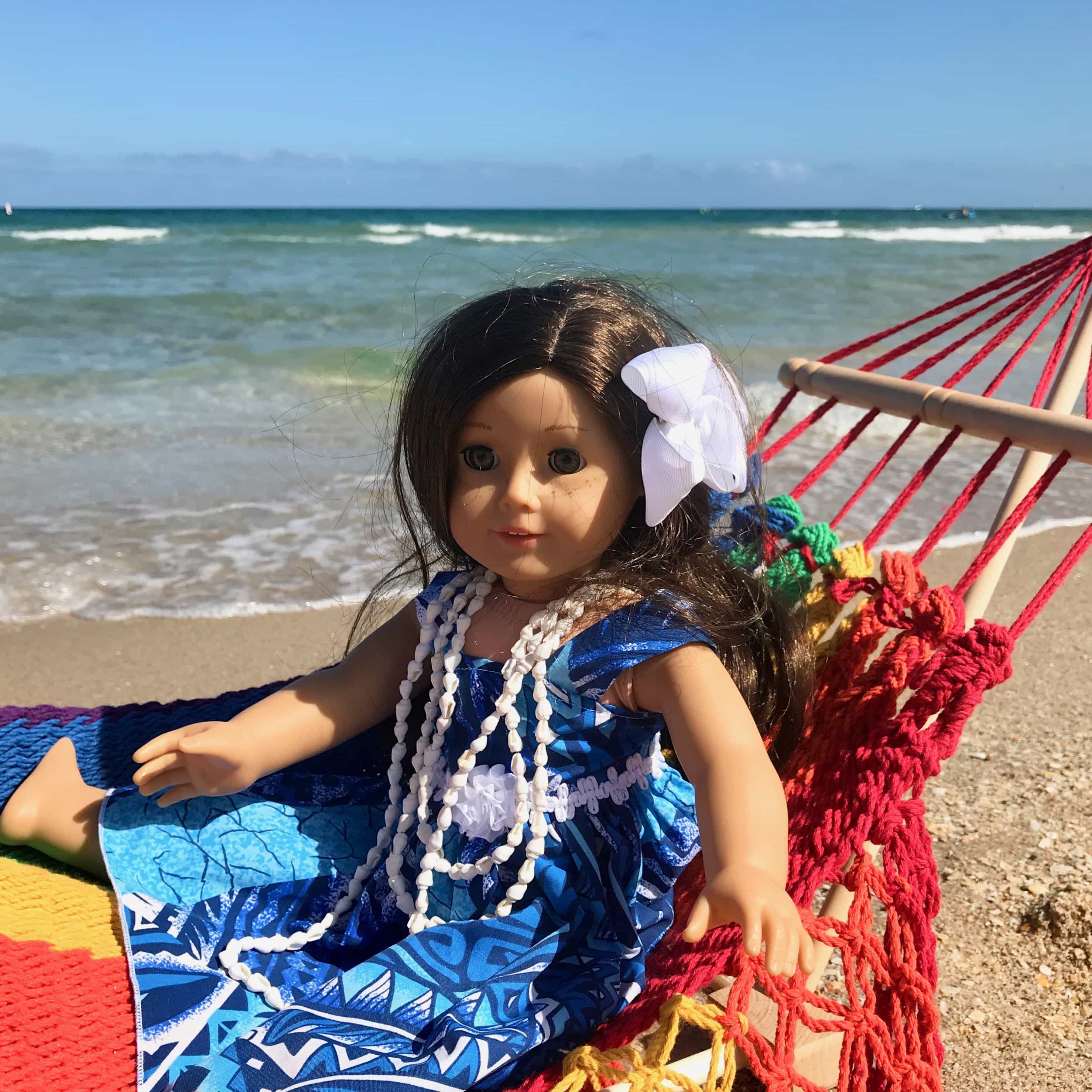 American Girl Doll at the beach sitting on a hand-knit rainbow colored hammock for 18 inch dolls