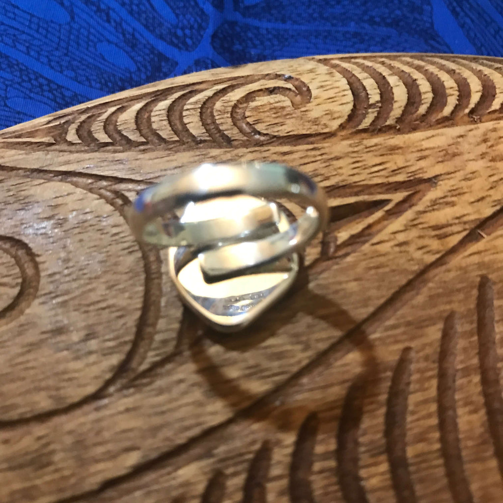 Back view of blue beach glass ring showing adjustable size setting on stirling silver