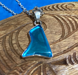 Close up view of a blue beach glass pendant necklace with an abstract shape in a stirling silver setting | Aloha Products USA