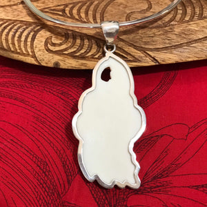 Back view showing the smooth bone surface of a hibiscus flower pendant set in stirling silver