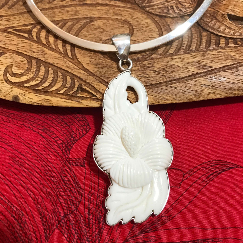 Island jewelry Hawaiian carved hibiscus bone flower pendant with a stirling silver setting | Aloha Products USA