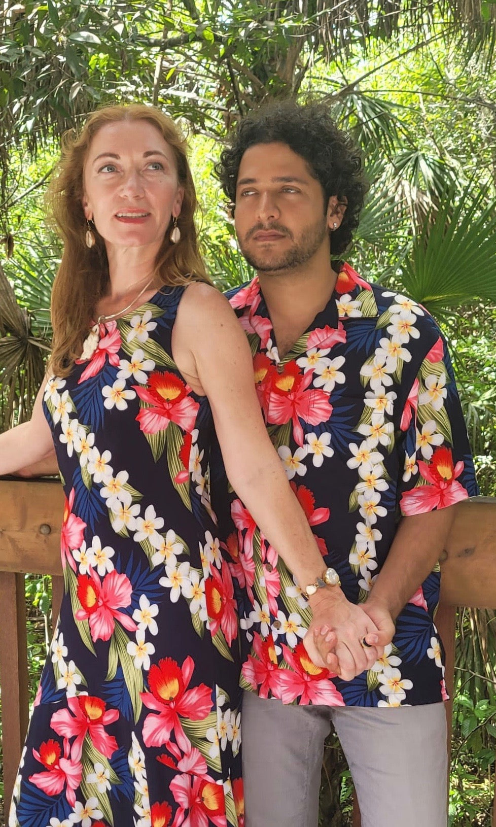 Hawaiian couple wearing matching blue hibiscus shirt and dress outfits | Aloha Products USA