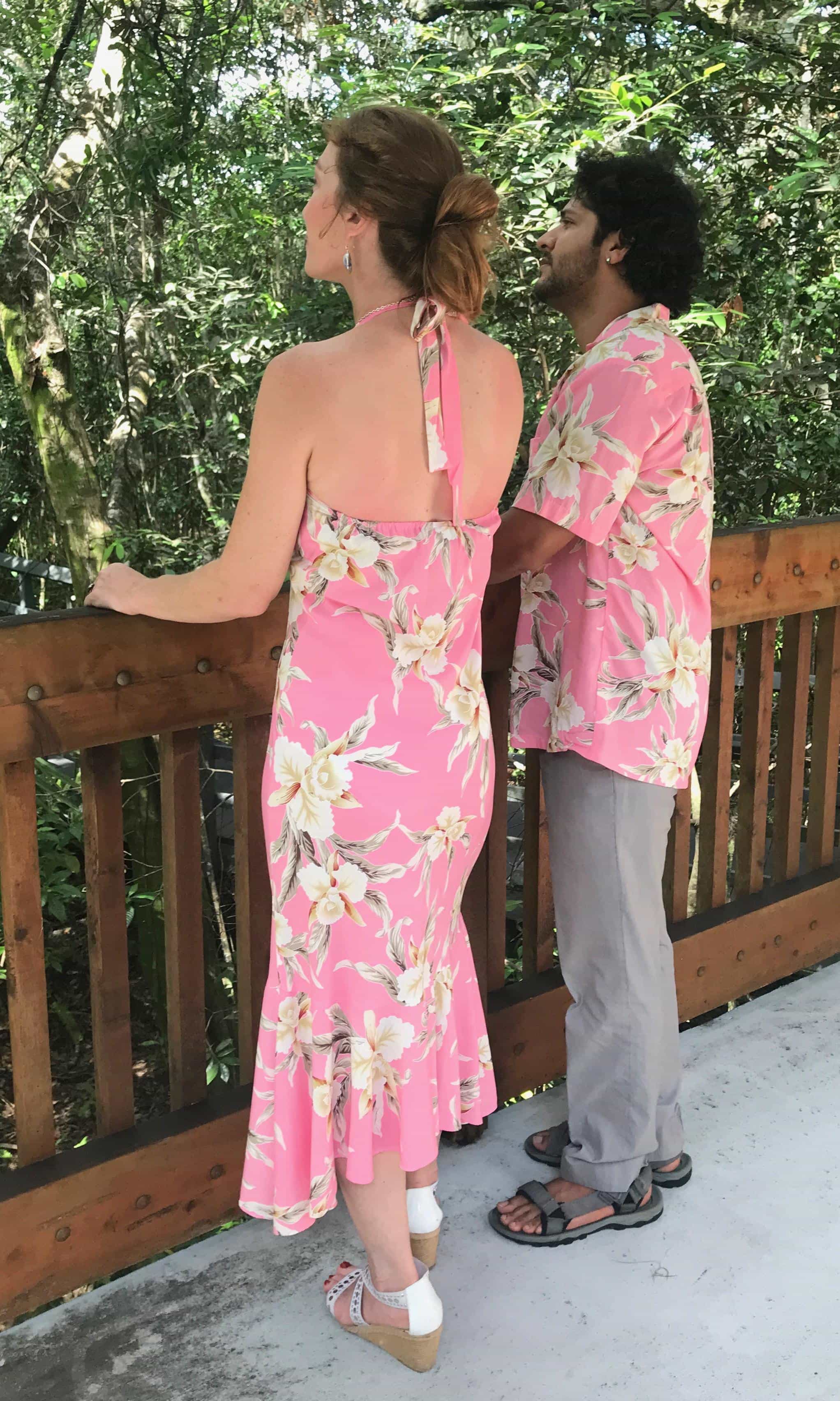 Hawaiian couple wearing matching pink orchid dress and shirt for family outfit | Aloha Products USA