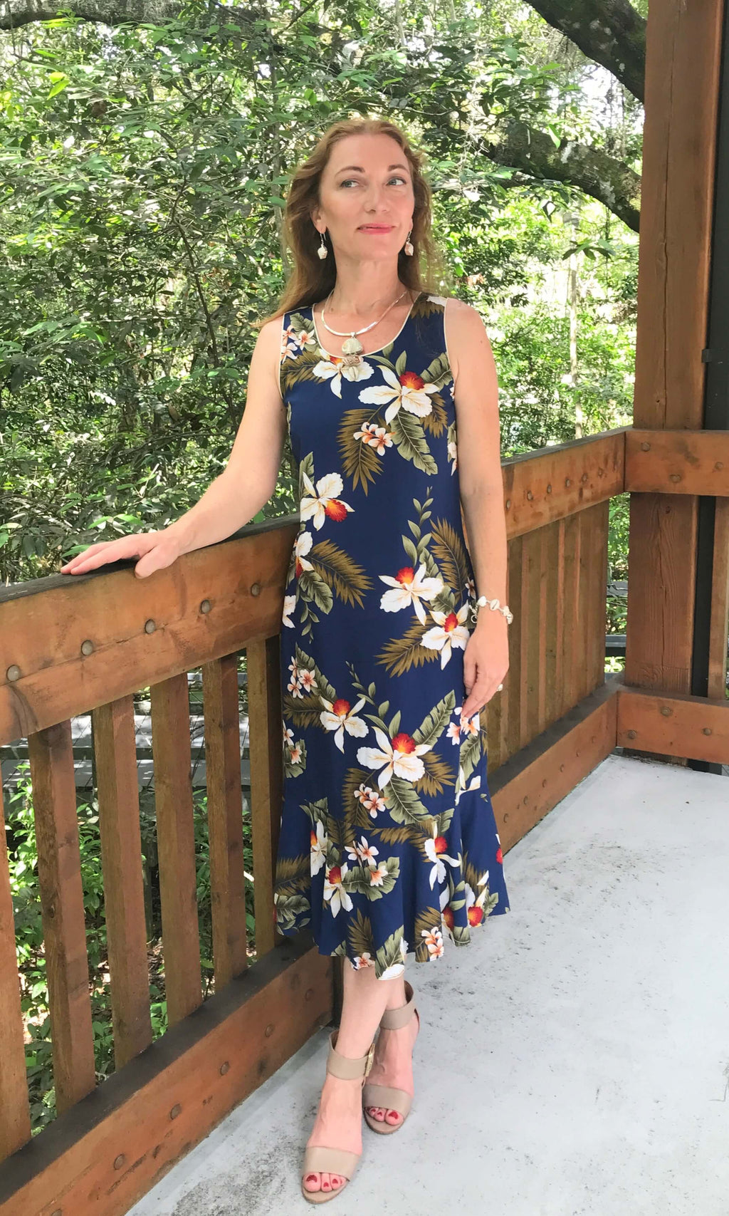 Woman wearing Hawaiian navy blue orchid midi dress for matching couple outfit | Aloha Products USA