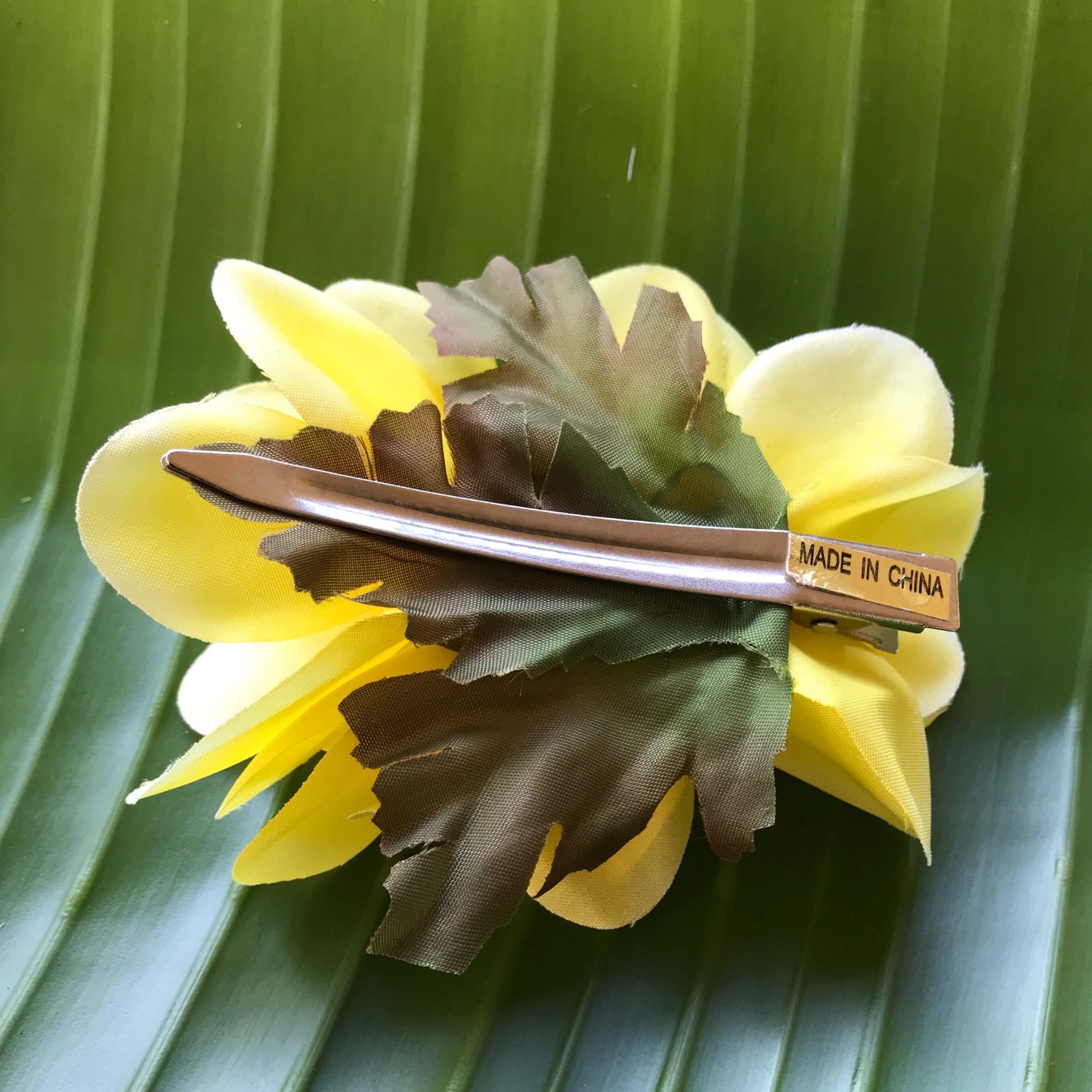 Back view of a yellow plumeria silk flower hair clip