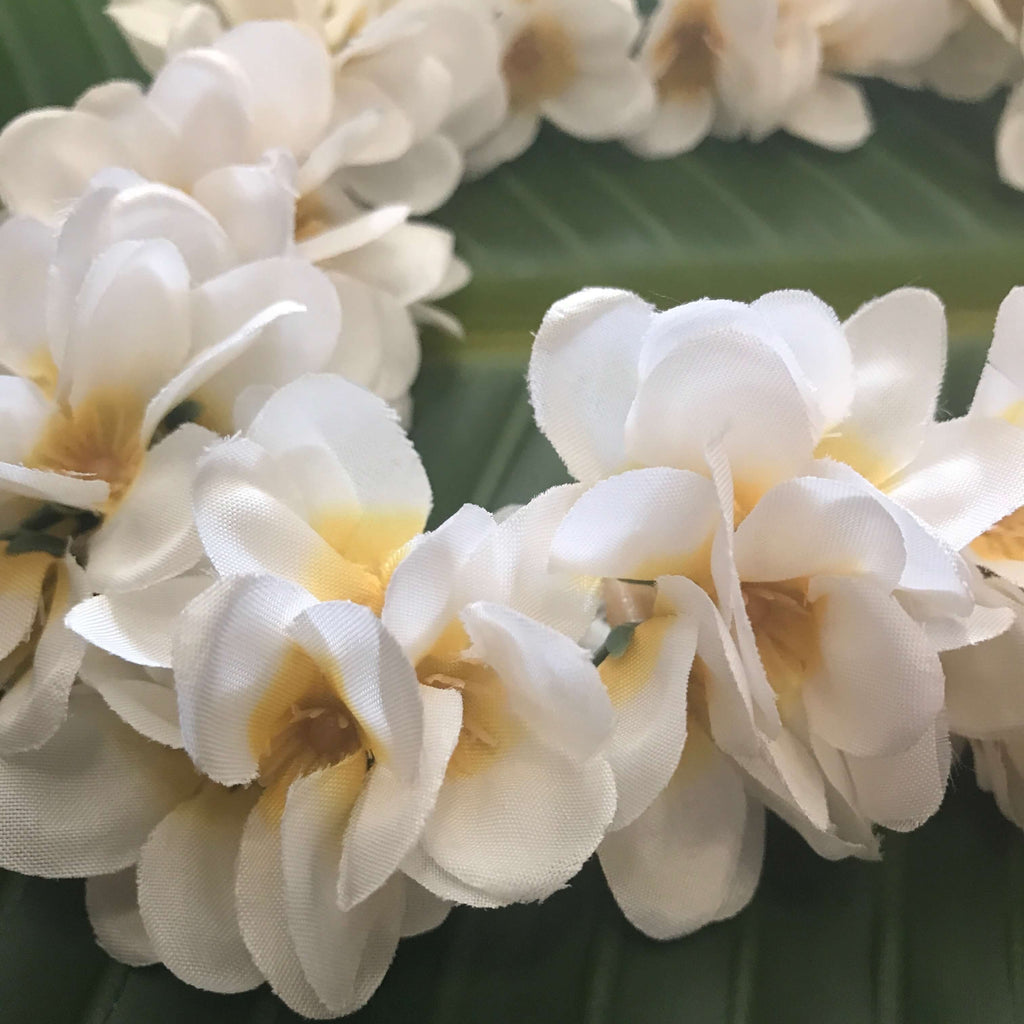 Close up view of Hawaiian silk head lei made with small plumeria flowers for headband