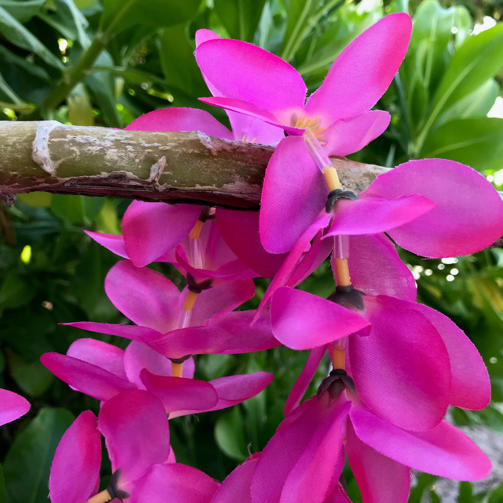 Close up view of a hot pink plumeria Hawaiian silk lei | Aloha Products USA