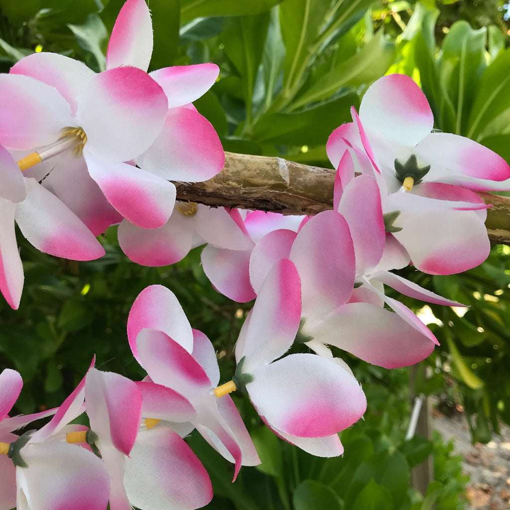 Close up view of a pink and white plumeria Hawaiian silk lei | Aloha Products USA