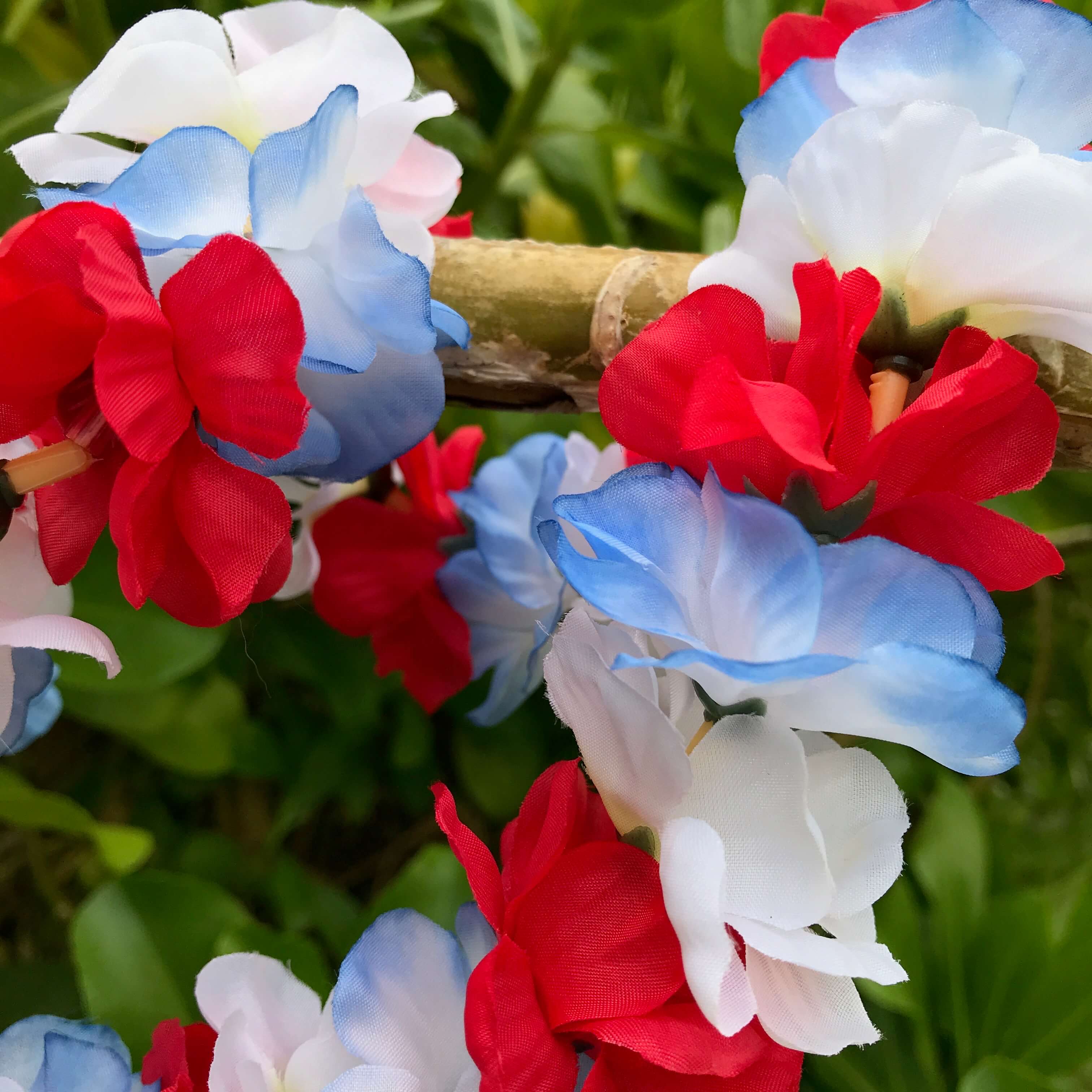 Close up view of a red white and blue rose flower Hawaiian silk lei | Aloha Products USA