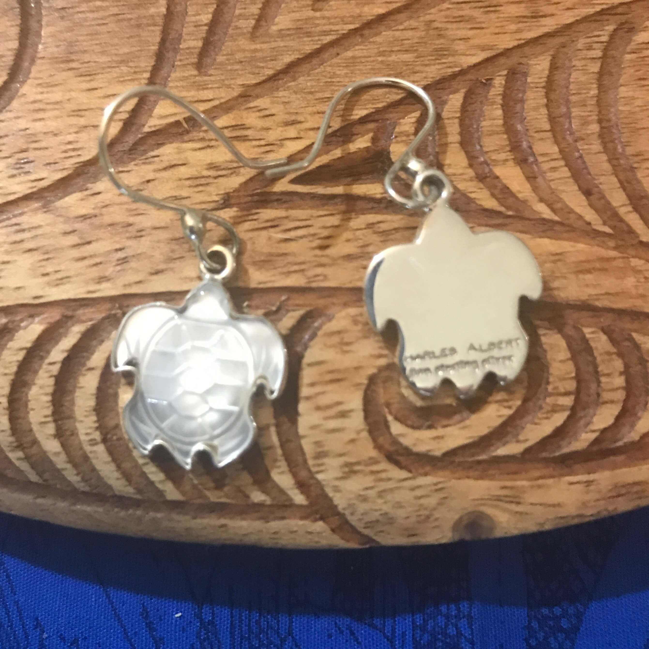 Back view of mother of pearl earrings set with stirling silver setting