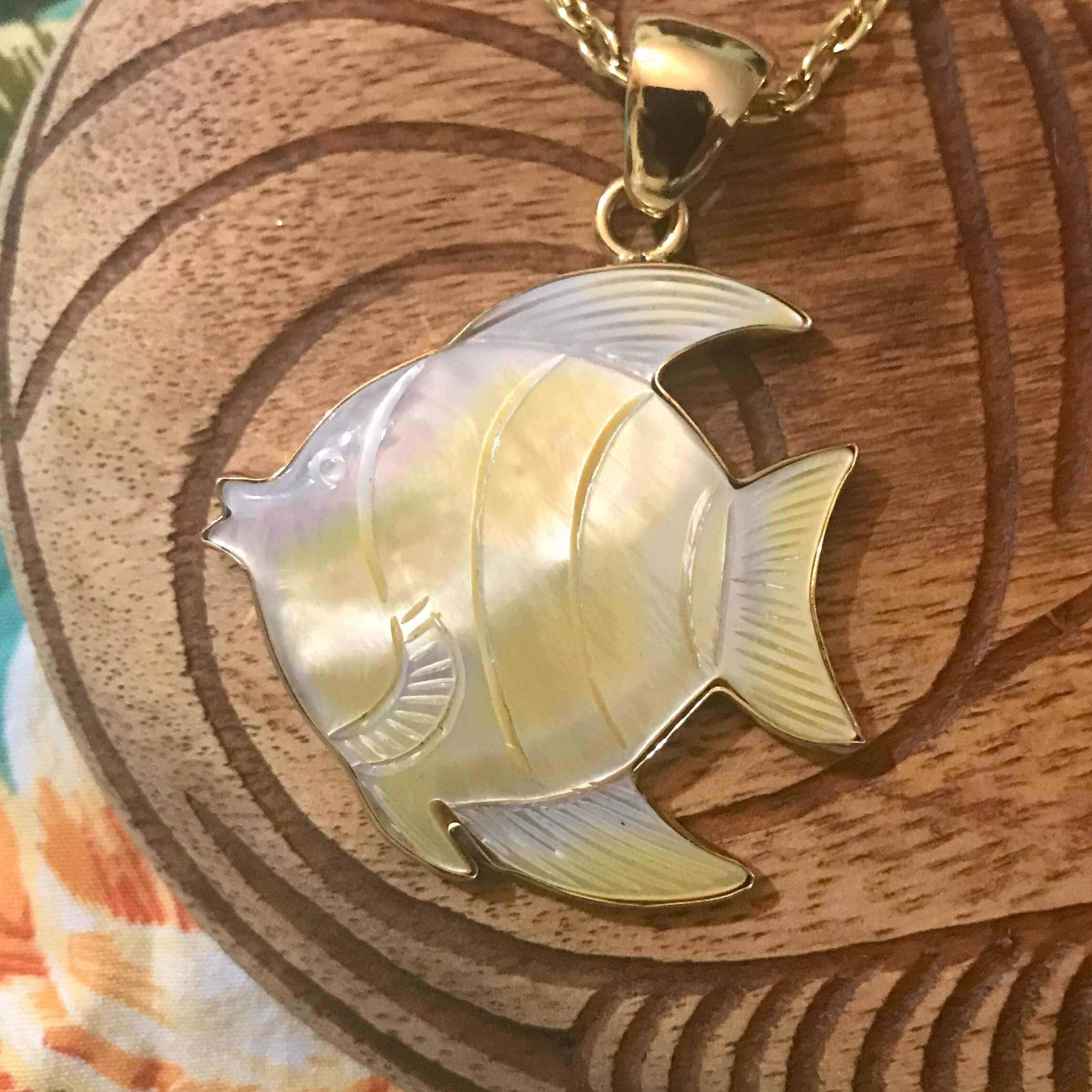 close up view of mother of pearl sunfish pendant necklace set on alchemia gold | Aloha Products USA