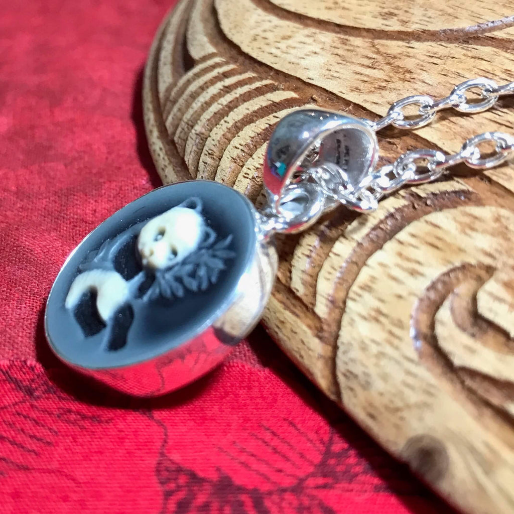 Close up view of a panda bear cameo pendant set in stirling silver | Aloha Products USA