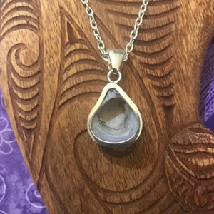 Back view showing the under side of a purple clam shell pendant set in stirling silver
