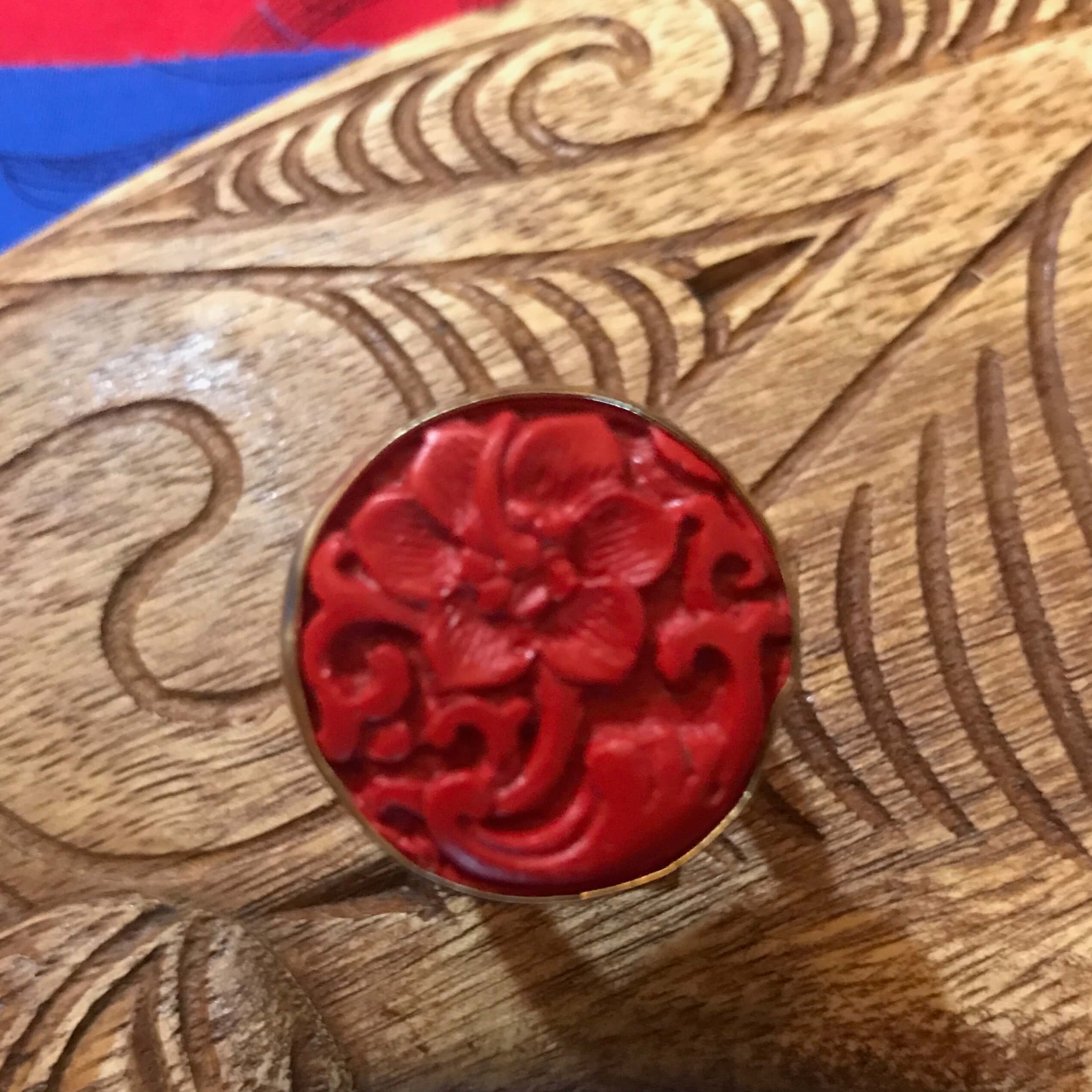 Island jewelry red cinnibar ring with carved flower design set on alchemia gold | Aloha Products USA