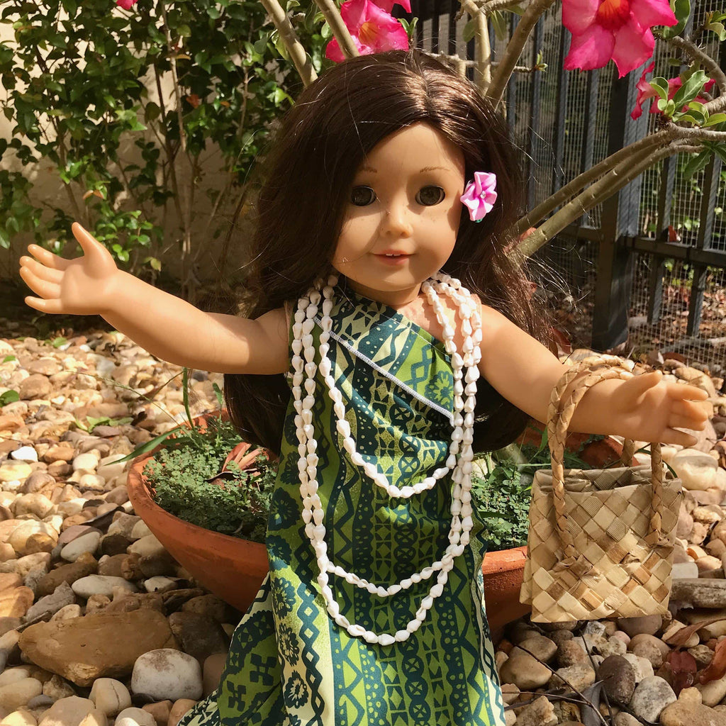 18 inch American Girl Doll wearing a long green Hawaiian holoku hula dress outfit with a shell lei and woven hand bag accessories